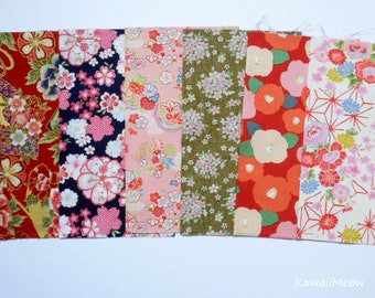 May include: Eight fabric swatches with different floral patterns. The fabrics are in shades of red, pink, green, blue, and white. The patterns include cherry blossoms, geometric designs, and traditional Japanese motifs.