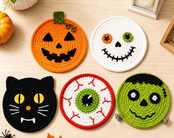 May include: Five round crochet coasters featuring Halloween designs: an orange pumpkin, a white skull with mismatched eyes, a black cat face, a white eyeball with red veins and a green iris, and a green monster face with black hair and bolts.