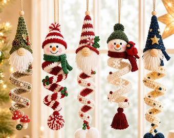 May include: Five hanging crochet ornaments featuring gnomes and snowmen with spiral tails. The figures include a green gnome with mushrooms, a striped snowman, a red-hatted gnome, a snowman with a cardinal, and a blue gnome with star accents.
