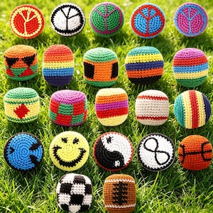 May include: A collection of colorful, handmade crochet balls, each with unique designs and patterns. The balls feature various colors, including red, green, blue, yellow, and orange, and are arranged on a bed of green grass. Some balls have peace signs, smiley faces, and yin-yang symbols.