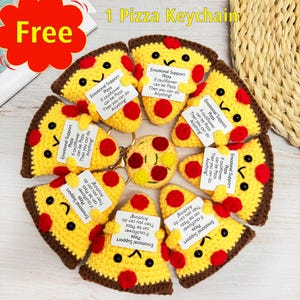 Puede incluir: Un conjunto de ocho llaveros de pizza en forma de rebanada hechos a crochet con un pequeño llavero de pizza en crochet en el centro. Cada llavero de pizza en forma de rebanada tiene un diseño de crochet rojo y amarillo con una cara sonriente y una pequeña etiqueta blanca que dice "Emotional Support Pizza If cauliflower can be pizza then you can do anything!"