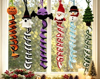 May include: Six hanging crochet ornaments featuring a pumpkin, ghost, bat, Santa Claus, snowman, and Christmas tree. Each figure is attached to a long, colorful spiral tail made of yarn, suspended from a wooden ring by a string loop.