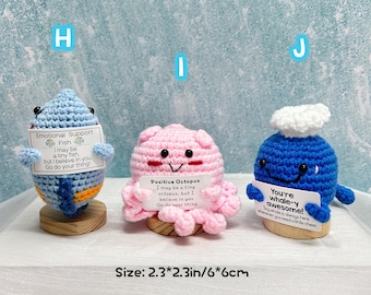 May include: Three crocheted plush toys: a blue fish, a pink octopus, and a blue whale. Each has a small sign with an inspirational message. The fish is 2.3 x 3.1 inches, the octopus is 2.3 x 2.3 inches, and the whale is 2.3 x 2.7 inches.