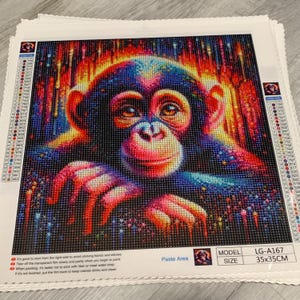 May include: A square diamond painting kit featuring a colorful chimpanzee portrait with vibrant red, blue, and yellow hues. The canvas includes a color legend, a 35x35 cm paste area, and model number LG-A167 printed on the bottom right corner.