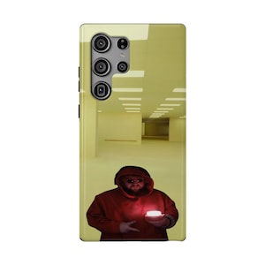 May include: A rectangular smartphone case featuring a yellow-toned interior room graphic with a person wearing a red hooded sweatshirt, sunglasses, and a beard, holding a glowing circular object while making a peace sign gesture with one hand.