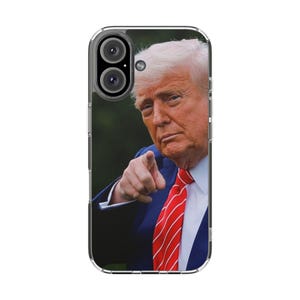 May include: Clear phone case featuring a portrait of a man in a blue suit and red tie, pointing towards the viewer. The case has a clear border and a dual-lens camera cutout.