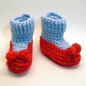 May include: A pair of baby booties crocheted in blue and red yarn. The booties have a pointed toe and a ruffled trim.