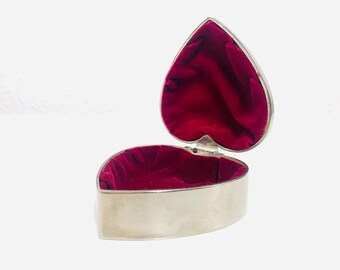 Vintage silver plated heart shaped jewellery box with embossed roses on the lid and red velvet inside
