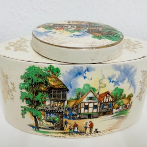 Vintage Lancaster and Sandland half pound tea jar, made in 1940s. It is beautifully decorated with a scene from Somerset on both sides.