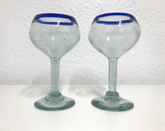 A pair of vintage hand blown, blue rim cobalt wine glasses