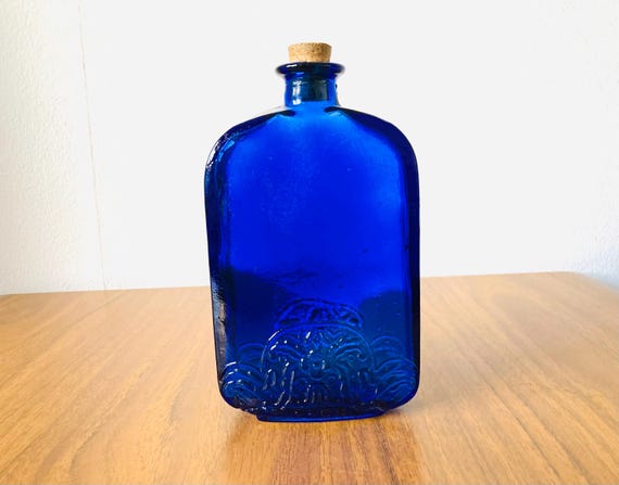 Vintage vibrant blue cobalt glass bottle, with art nouveau design style