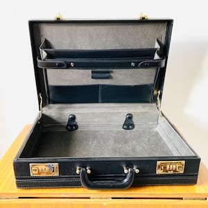 Vintage black leather briefcase, with combination lock.