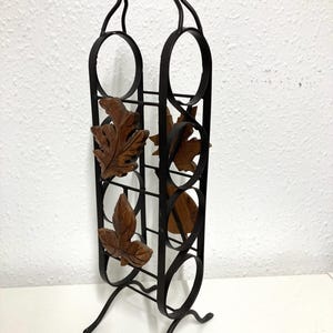 Vintage wrought iron wine rack with leaf design