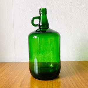 Vintage large green glass bottle, with a small handle on the top. The bottle was made in France in the 1950s, it is stamped on the bottom