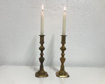 Vintage pair of solid brass candlestick holders with a square base