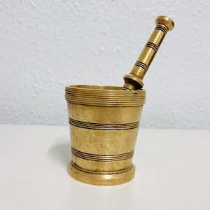 Vintage brass apothecary mortar and pestle, they are signed on the bottom