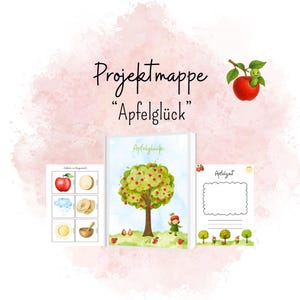 Könnte beinhalten: Eine Sammlung illustrierter Schreibwaren mit Apfelmotiv. Das Hauptobjekt ist ein Notizbuch mit einer Baumillustration und dem Text "Apfelglück". Weitere Artikel sind eine Karte mit leerem Feld und ein Bogen mit illustrierten Karten.