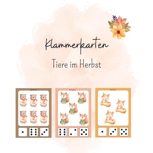 May include: Educational cards with watercolour illustrations of bears and foxes in autumn outfits. The cards include dice patterns for matching games. The text "Klammerkarten Tiere im Herbst" is displayed in a decorative font.