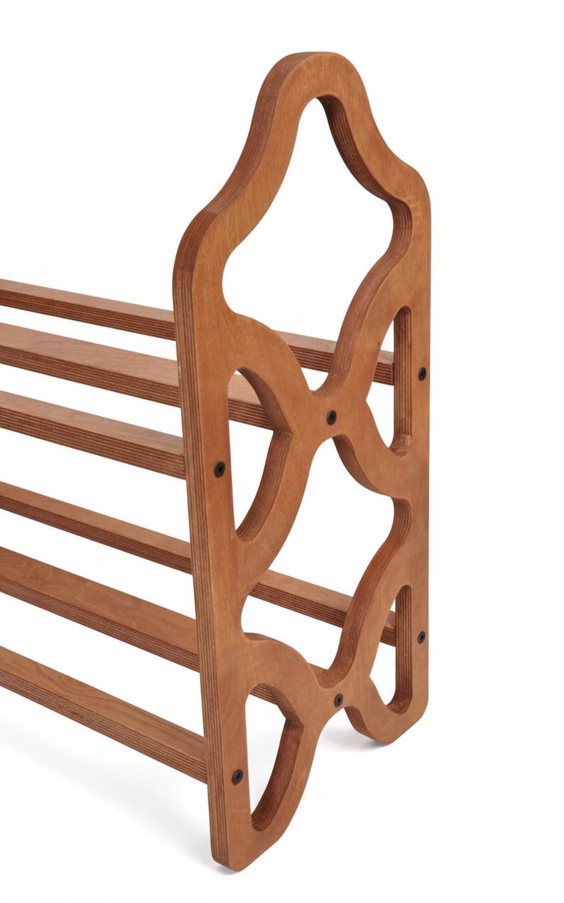 May include: Wooden shoe rack with a decorative cutout design on the side panel. The rack has multiple horizontal shelves for shoe storage. The wood has a warm, natural finish, and the design is functional and stylish.
