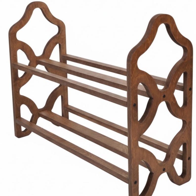 May include: A wooden shoe rack with a dark brown finish. The rack has three shelves and decorative side panels with an open, geometric design. The rack is approximately 30 inches wide, 12 inches deep, and 24 inches tall.