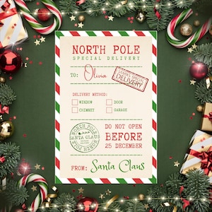 May include: A Christmas-themed card with a green and white border. The card reads "North Pole Special Delivery" and is addressed to "Olivia" with a "Santa's Special Delivery" stamp. It includes delivery method options and a "Do Not Open Before 25 December" message.