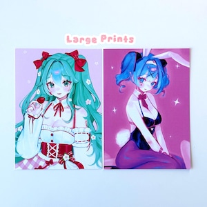 May include: Two art prints featuring anime-style characters with blue hair and large eyes. One character wears a red and white outfit with a bow, the other a bunny-themed outfit. The text "Large Prints" is above the prints.