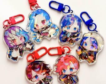 May include: Collection of seven anime-style character keychains. Each keychain features a colorful, detailed illustration of a character with blue, red, and purple hair. The keychains have red and blue clasps.