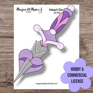 May include: A printable papercraft pattern of a purple and silver heart-shaped dagger. The pattern is for a 24-piece project. The text "Heart Dagger 24 Pieces" is at the top of the image. The text "Sugar & Spice Crafts" is at the top left of the image. The text "SugarAndSpiceCrafts.com" is at the bottom of the image. The text "Hobby & Commercial License" is at the bottom right of the image.
