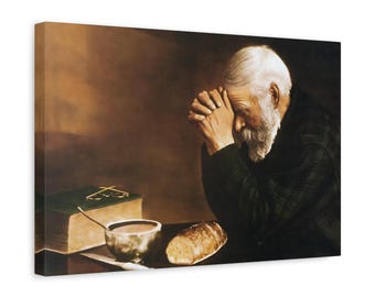 Puede incluir: Un lienzo impreso que muestra a una persona mayor con barba y cabello blancos, con las manos juntas en oración. A su lado hay un libro verde, un pequeño cuenco de metal con una cuchara y un pan, sobre un fondo oscuro de tonos cálidos.