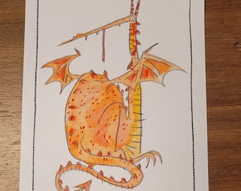 May include: A watercolor illustration of a dragon with orange and yellow hues. The dragon has large wings, a long neck, and a spiky tail. The artwork is framed with a black border and decorative corner elements.