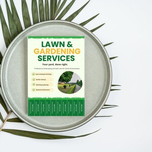 May include: A flyer for lawn and gardening services, featuring text in green and yellow. The flyer includes a list of services and a picture of a well-manicured lawn. The flyer is on a gray plate with green leaves.