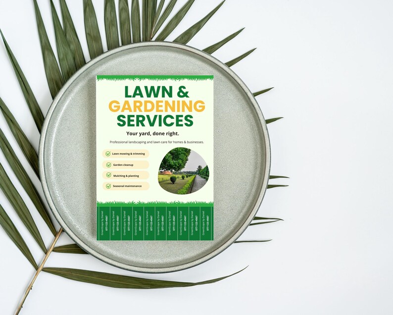 May include: A flyer for lawn and gardening services, featuring text in green and yellow. The flyer includes a list of services and a picture of a well-manicured lawn. The flyer is on a gray plate with green leaves.