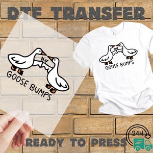 May include: White t-shirt with a black and white cartoon goose design and the words "GOOSE BUMPS". A clear DTE transfer with the same design is shown. The words "READY TO PRESS" are at the bottom.