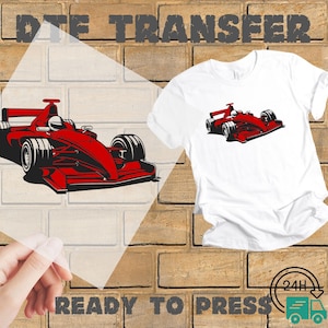 May include: White t-shirt with a red race car graphic. The image also shows a DTE transfer of the same design and the words "READY TO PRESS". The background is a brick wall.