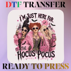 May include: A DTF transfer featuring three women with elaborate hairstyles and sunglasses, wearing pink feathered coats. The text reads I'M JUST HERE FOR THE HOCUS POCUS. The design includes bats, a skull, and a pink cup labeled WITCHES GET STITCHES.