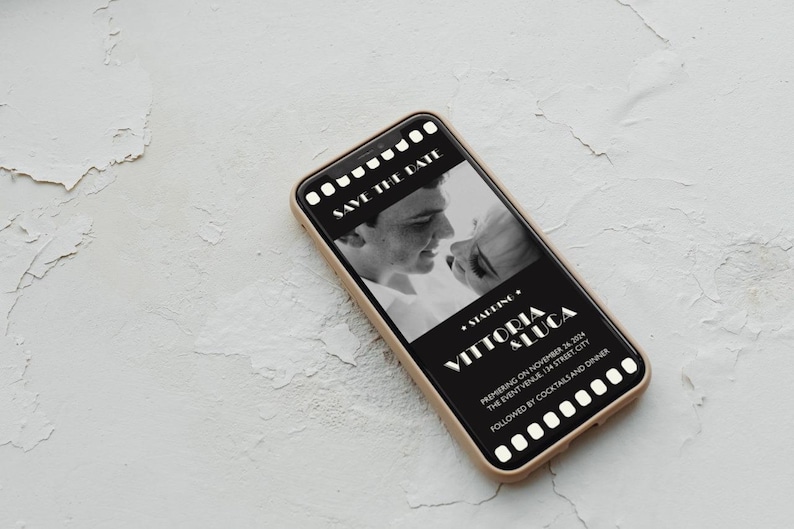May include: A black and white photo of a couple on a smartphone screen with a film strip border. The text reads "Save the Date" and "Starring Vittoria & Luca" with the date and location of the event.