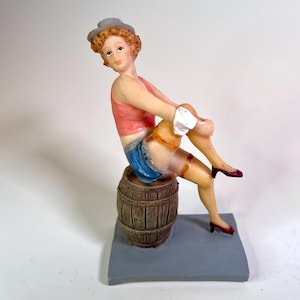 Vintage Pin-Up Style Figurine – Retro Woman on Barrel Collectible