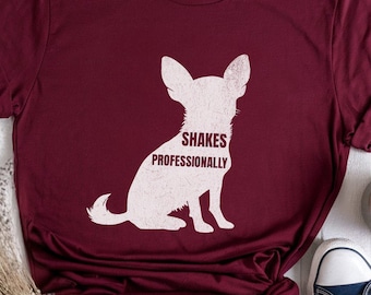May include: A maroon t-shirt with a white silhouette of a chihuahua and the text "Shakes Professionally".
