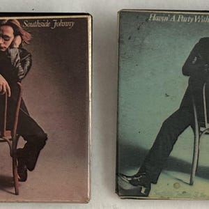 May include: Two vintage album covers side-by-side. Each features a seated figure in a black suit, leaning on a chair. The album title "Havin' A Party With" and artist "Southside Johnny" are visible. The covers have a retro aesthetic.