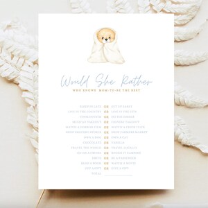 May include: A baby shower game card featuring a watercolour illustration of a teddy bear in a blanket. The card has the text "Would She Rather" in a script font, with various choices for the mum-to-be to choose from.