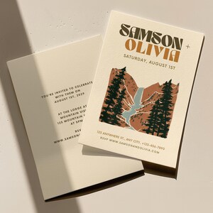 May include: A wedding invitation with a mountain landscape illustration in shades of brown, green, and blue. The text reads "SAMSON + OLIVIA" in a retro font and "SATURDAY, AUGUST 1ST".