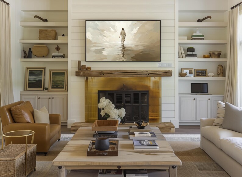 a cozy living room with a fireplace, a large painting of a person walking, and a wooden coffee table with various items on it.