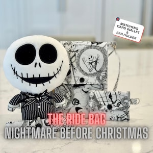 May include: A plush Jack Skellington doll stands next to a matching set of accessories. The accessories include a crossbody bag, card wallet, and ear holder, all with a black and white Nightmare Before Christmas print. The text "THE RIDE BAG" and "NIGHTMARE BEFORE CHRISTMAS" are displayed.
