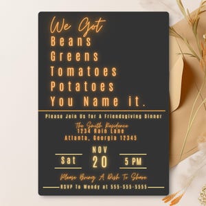 May include: A rectangular black invitation card with orange text that reads: We Got Beans Greens Tomatoes Potatoes You Name it. Please Join Us for A Friendsgiving Dinner, The Smith Residence, 1234 Rain Lane, Atlanta, Georgia 12345, Nov Sat 20 5 PM.