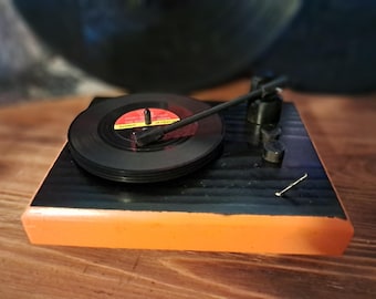 The perfect gift for the music lover in your life. Each handmade mini record player comes complete  with 4 miniature record coasters.