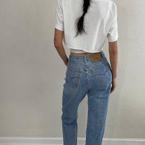 vintage Levis 501 button fly made for women high waisted faded Levis jeans made in USA size 27 x 32