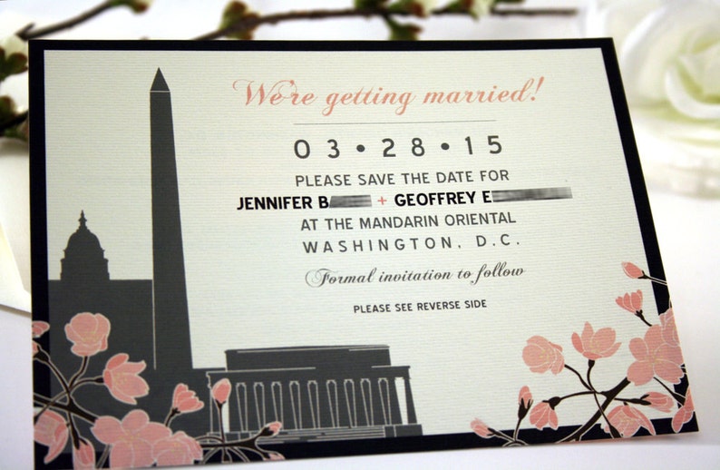 May include: Save the date card featuring a black and white illustration of the Washington Monument and the Lincoln Memorial. The card is decorated with pink cherry blossoms and the text "We're getting married! 03.28.15 Please save the date for Jennifer B + Geoffrey E at the Mandarin Oriental Washington, D.C. Formal invitation to follow. Please see reverse side."