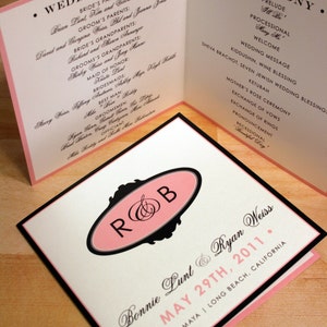 Puede incluir: Invitación de boda con un diseño rosa y negro. La invitación presenta los nombres de la pareja, la fecha de la boda y el texto "R&B" en un marco decorativo.