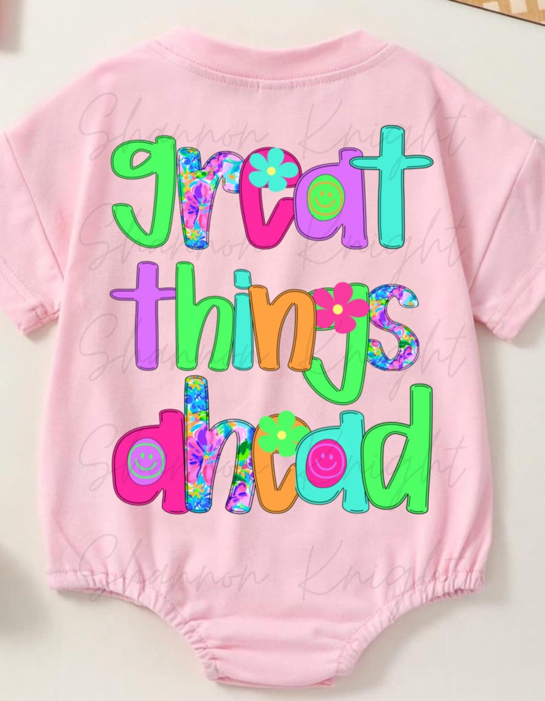 May include: Pink baby onesie with the text "great things ahead" in colorful letters with floral and smiley face designs.
