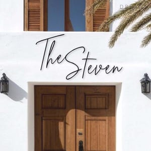 May include: A white building with a wooden door and a sign that reads "The Steven".